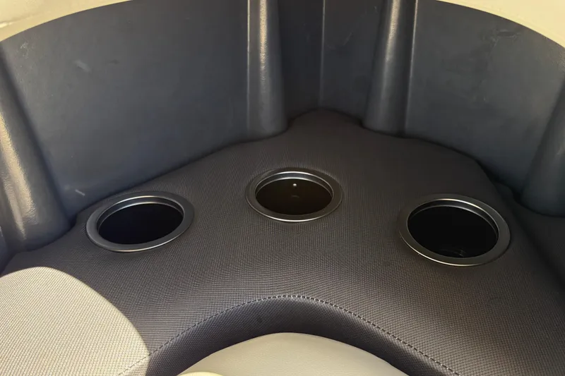 Slide: The Image of 2026 Sun Tracker Fishin' Barge 20 DLX interior with three cup holders. - 30
