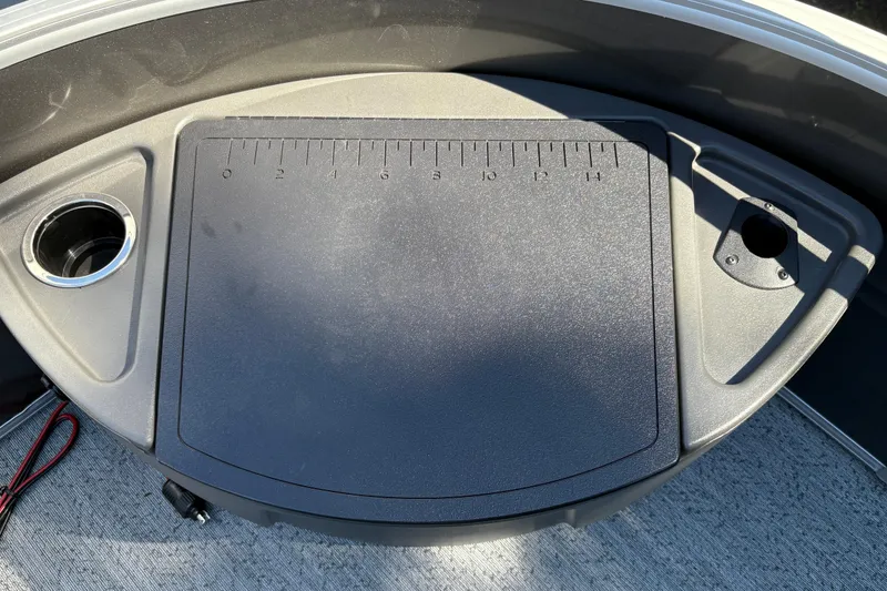 Slide: The Image of Fishing station on 2026 Sun Tracker Fishin' Barge 20 DLX with ruler and cup holder. - 19