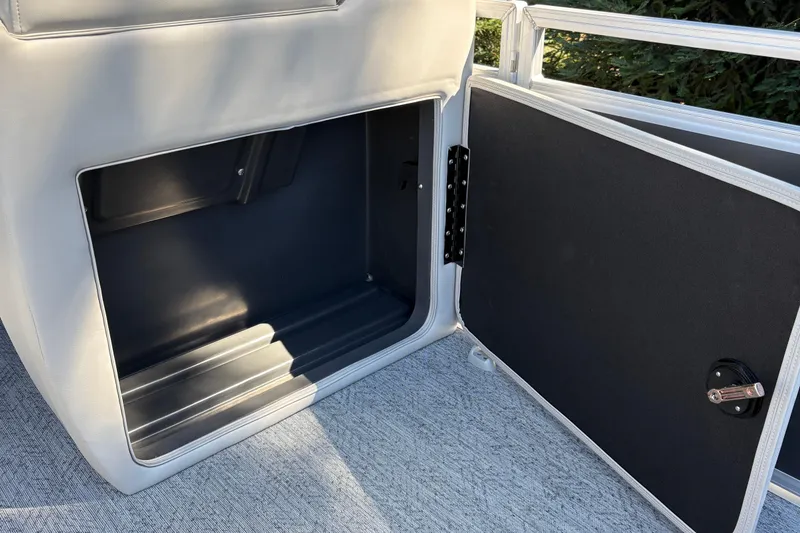 Slide: The Image of Open storage compartment on 2026 Sun Tracker Fishin' Barge 20 DLX pontoon boat. - 20