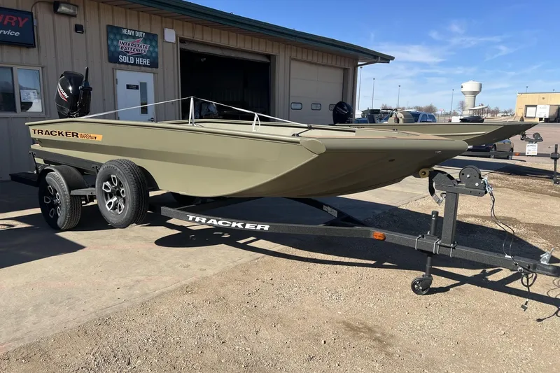 The Image of 2026 Tracker Grizzly 1756 T Marsh boat on trailer outside dealership. - 0
