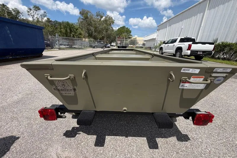 Slide: The Image of 2026 Tracker Grizzly 10 Jon boat on trailer, parked outdoors under a clear sky. - 4