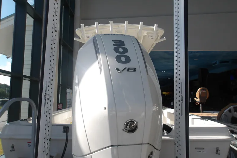 Slide: The Image of 2026 Ranger 2360 Bay boat with powerful 300 V8 engine displayed indoors. - 6