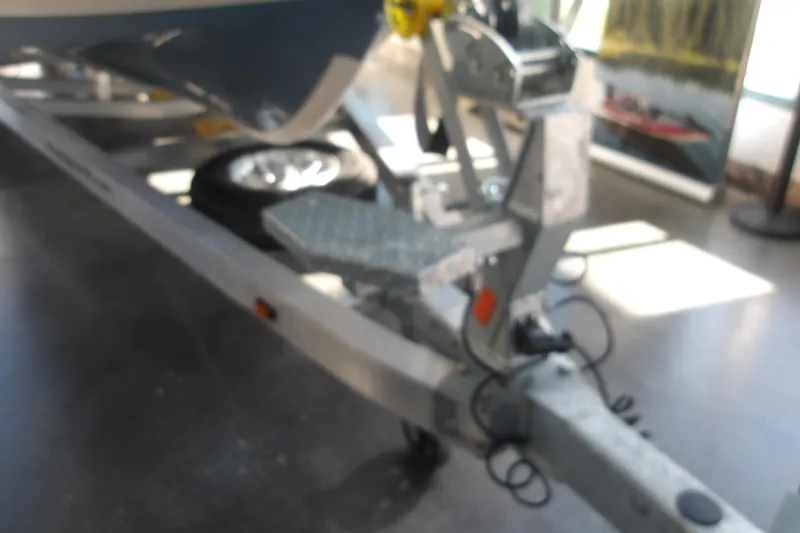 Slide: The Image of Blurry image of a 2026 Ranger 2360 Bay boat trailer hitch in a showroom. - 31