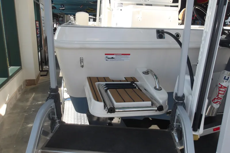 Slide: The Image of 2026 Ranger 2360 Bay boat with swim platform and ladder in showroom. - 8