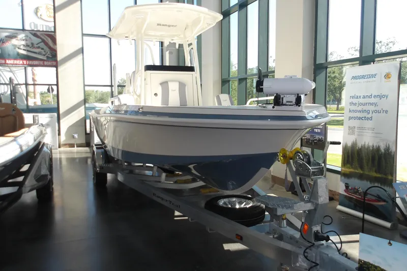 Slide: The Image of 2026 Ranger 2360 Bay boat displayed indoors on a trailer. - 32