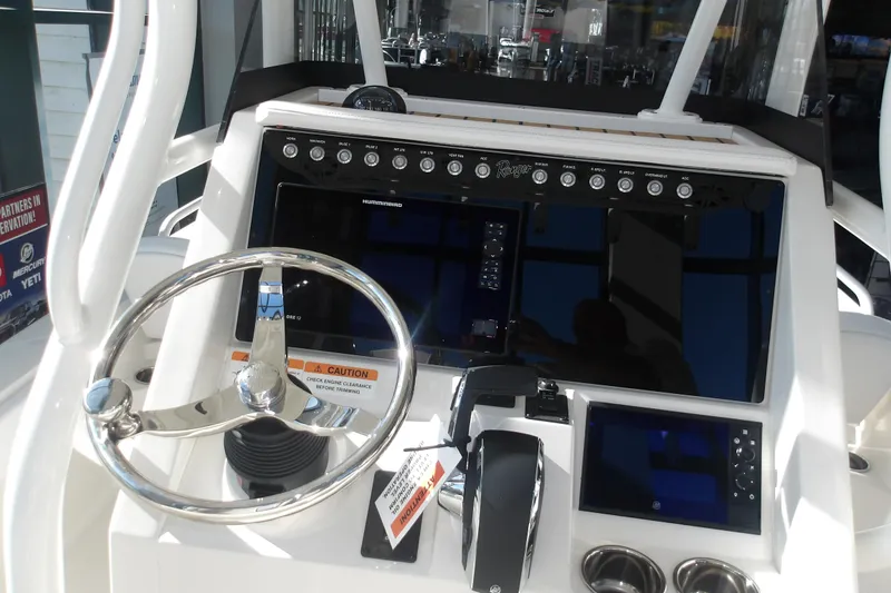 Slide: The Image of 2026 Ranger 2360 Bay boat dashboard with steering wheel and control panel. - 16