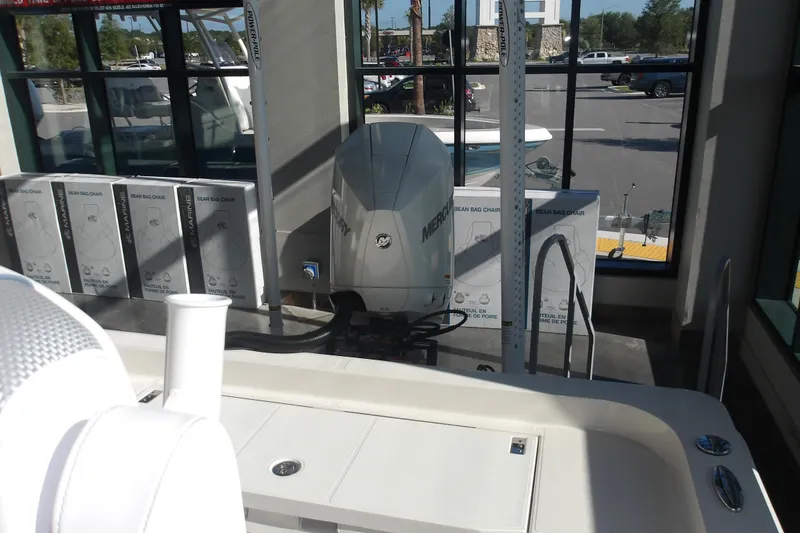 Slide: The Image of 2026 Ranger 2360 Bay boat with Mercury engine displayed indoors. - 27