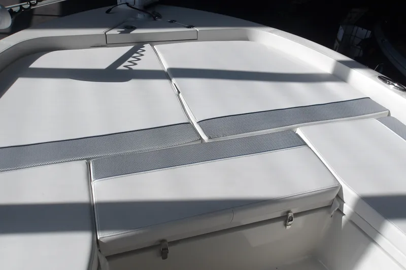 Slide: The Image of 2026 Ranger 2360 Bay boat interior with cushioned seating and storage compartments. - 21