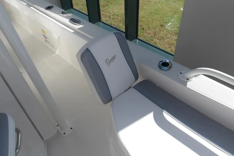 Slide: The Image of 2026 Ranger 2360 Bay boat interior with cushioned seating and cup holder. - 22