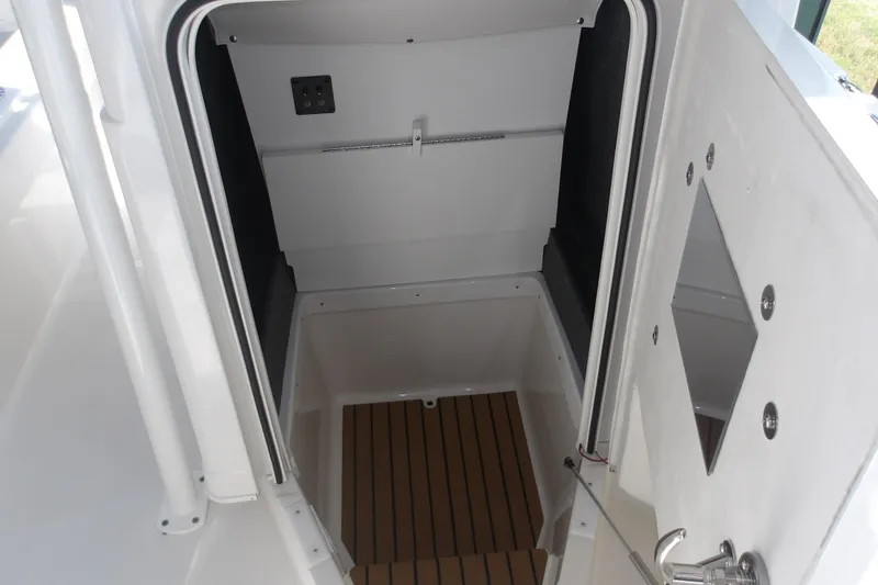 Slide: The Image of Interior view of 2026 Ranger 2360 Bay boat cabin with wooden flooring. - 19