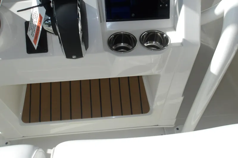 Slide: The Image of Interior of 2026 Ranger 2360 Bay boat with cup holders and control panel. - 30