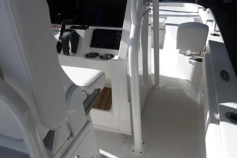 Slide: The Image of Interior view of 2026 Ranger 2360 Bay boat, featuring sleek white seating and modern controls. - 13