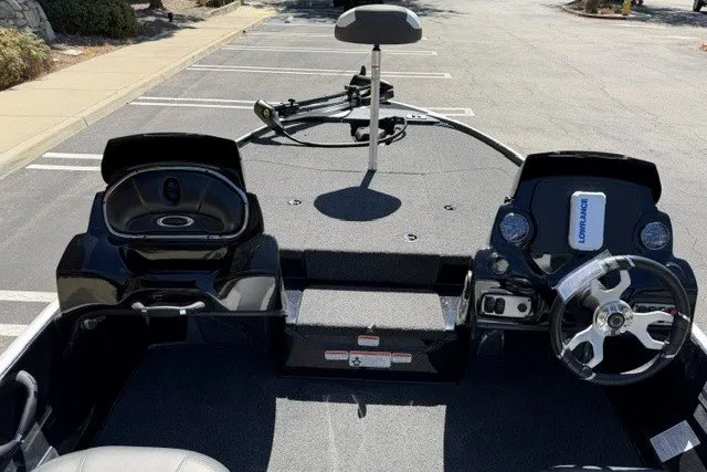 Slide: The Image of 2026 Nitro Z17 boat interior with steering wheel and control panel in a parking lot. - 6