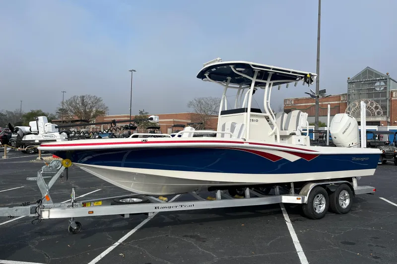 The Image of 2026 Ranger 2510 Bay boat on trailer in parking lot, side view. - 0