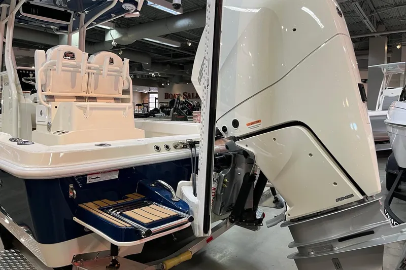 Slide: The Image of 2026 Ranger 2510 Bay boat with powerful outboard motor in showroom display. - 10