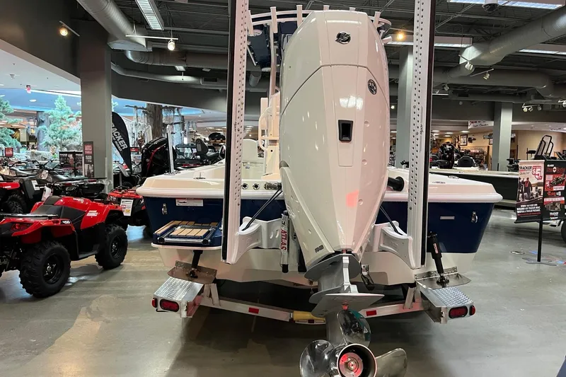 Slide: The Image of 2026 Ranger 2510 Bay boat displayed indoors, featuring a powerful outboard motor. - 11