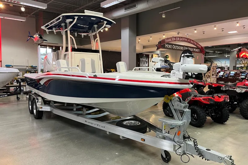 Slide: The Image of 2026 Ranger 2510 Bay boat on trailer in showroom, featuring sleek design and modern equipment. - 2