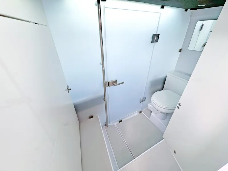 Slide: The Image of 2024 Axopar 37XC CROSS CABIN bathroom with modern shower and toilet. - 8