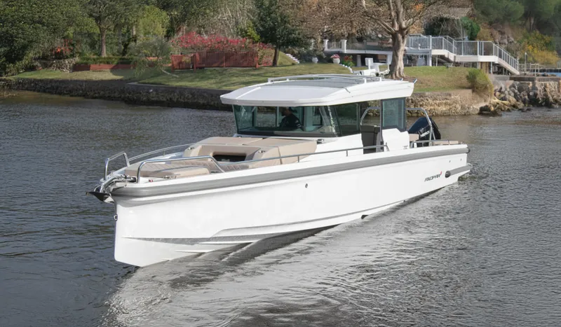 The Image of 2024 Axopar 37XC CROSS CABIN cruising on a calm river, showcasing sleek design and modern features. - 1