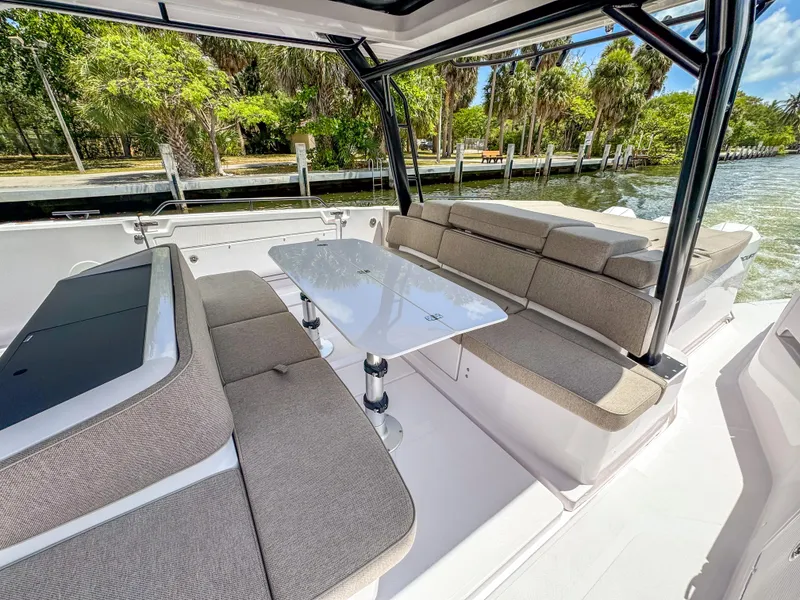 Slide: The Image of 2024 Axopar 45 ST BRABUS Trim Mediterrana boat interior with seating and table. - 11