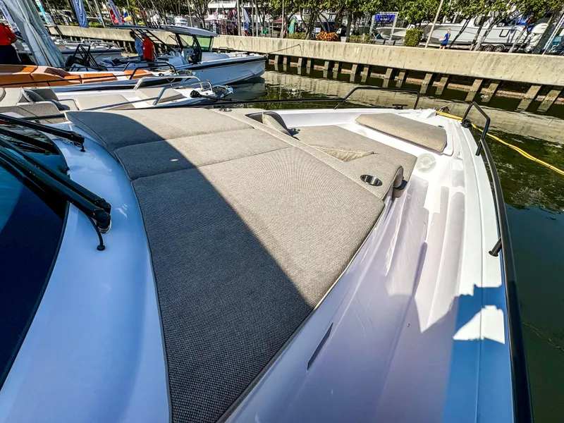 Slide: The Image of 2024 Axopar 45 ST BRABUS Trim Mediterrana boat docked, featuring spacious sunbathing area. - 15