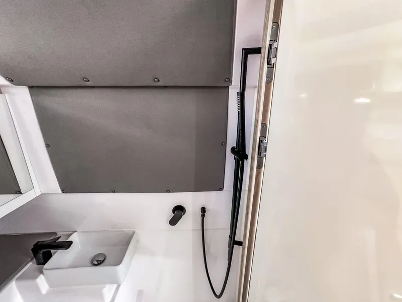 Slide: The Image of 2024 Axopar 45 ST BRABUS Trim Mediterrana bathroom interior with modern sink and shower. - 19