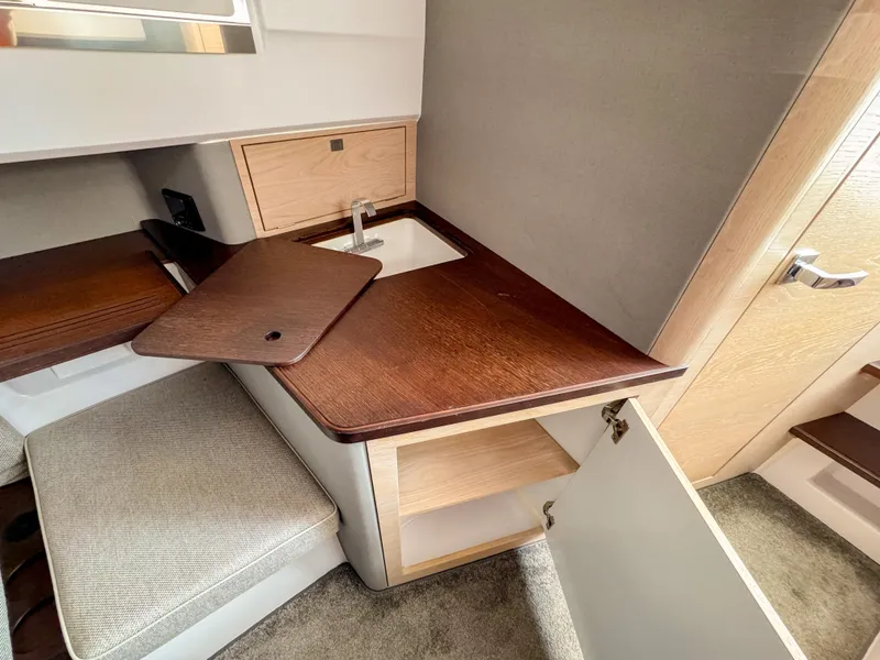 Slide: The Image of 2024 Axopar 45 ST BRABUS Trim Mediterrana interior with wooden cabinetry and sink. - 22