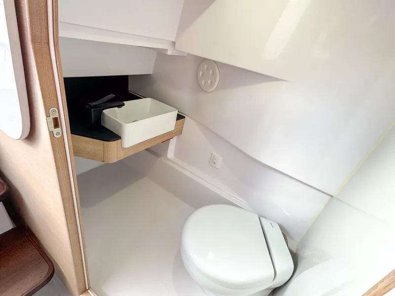 Slide: The Image of 2024 Axopar 45 ST BRABUS Trim Mediterrana bathroom with modern sink and toilet. - 31