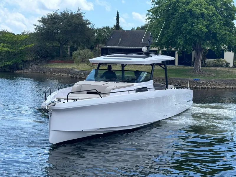 Slide: The Image of 2024 Axopar 45 ST BRABUS Trim Mediterrana cruising on a serene waterway. - 34