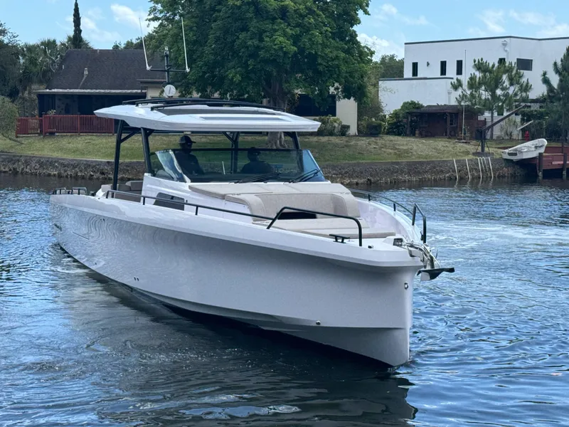 Slide: The Image of 2024 Axopar 45 ST BRABUS Trim Mediterrana cruising on a serene waterway. - 36