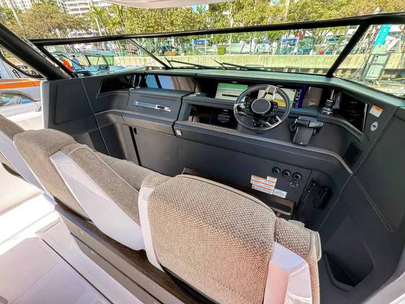 Slide: The Image of 2024 Axopar 45 ST BRABUS Trim Mediterrana cockpit with modern dashboard and steering wheel. - 13