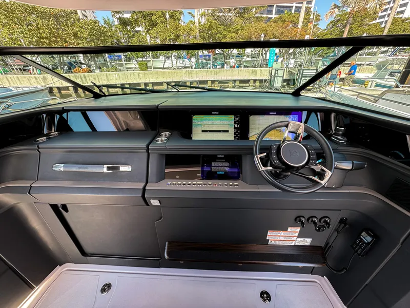 Slide: The Image of 2024 Axopar 45 ST BRABUS Trim Mediterrana helm with modern controls and sleek dashboard design. - 14