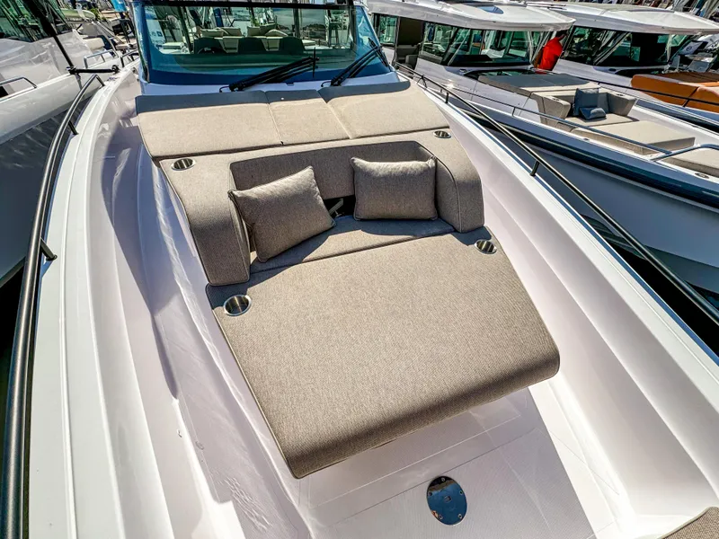 Slide: The Image of 2024 Axopar 45 ST BRABUS Trim Mediterrana with luxurious sunbed and cushions on deck. - 16