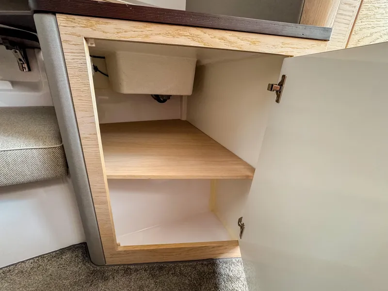 Slide: The Image of Open cabinet in 2024 Axopar 45 ST BRABUS Trim Mediterrana, showcasing interior shelving. - 23