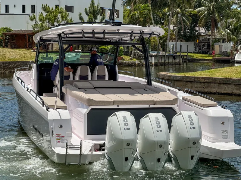 Slide: The Image of 2024 Axopar 45 ST BRABUS Trim Mediterrana boat with triple V8 engines in a canal setting. - 3