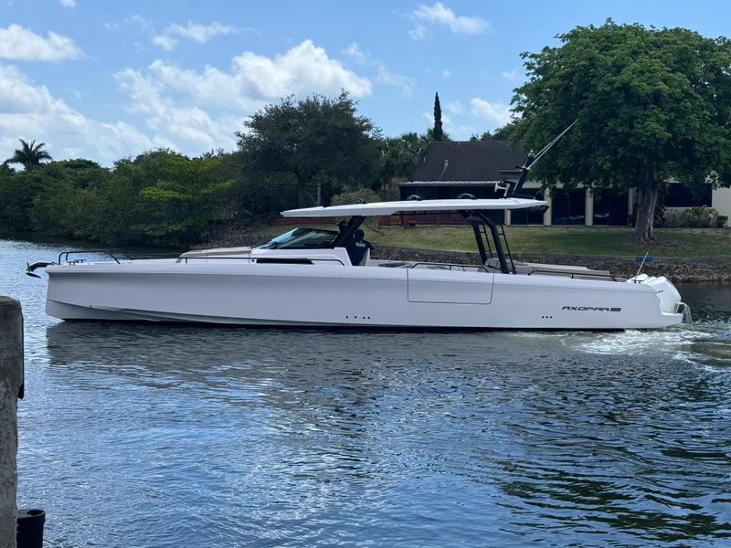 Slide: The Image of 2024 Axopar 45 ST BRABUS Trim Mediterrana cruising on a serene waterway. - 32