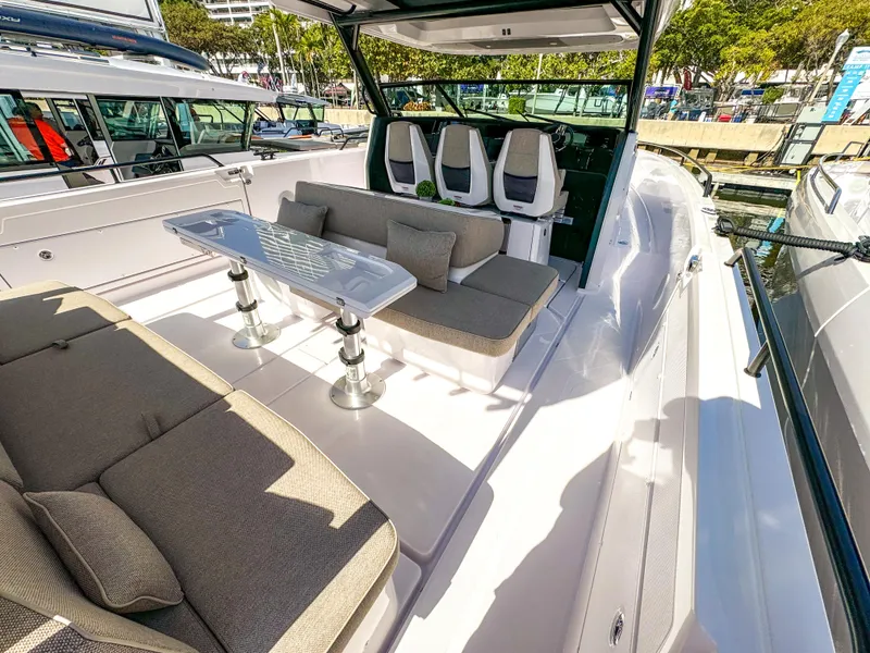 Slide: The Image of 2024 Axopar 45 ST BRABUS Trim Mediterrana boat interior with seating and table. - 5