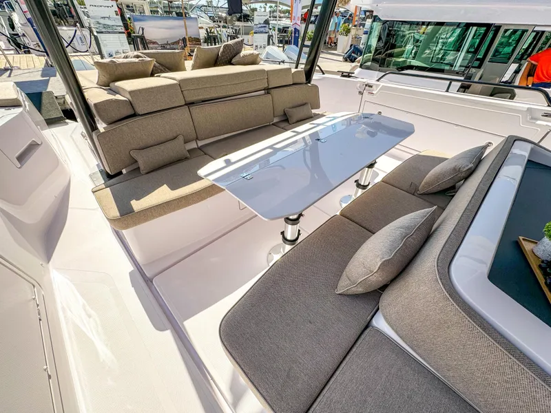 Slide: The Image of 2024 Axopar 45 ST BRABUS Trim Mediterrana boat interior with luxurious seating and table. - 6