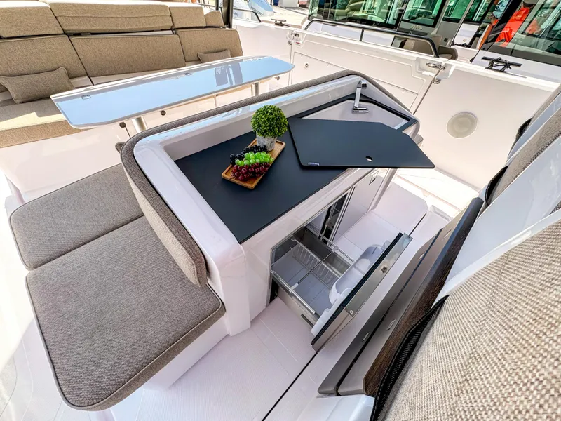 Slide: The Image of 2024 Axopar 45 ST BRABUS Trim Mediterrana interior with seating and table setup. - 8