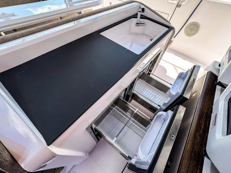 Slide: The Image of 2024 Axopar 45 ST BRABUS Trim Mediterrana kitchen area with sleek design and modern amenities. - 9