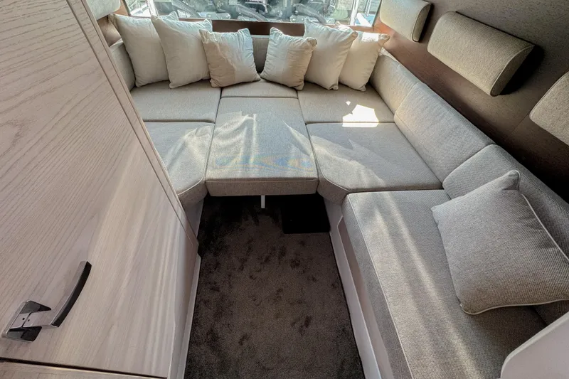 Slide: The Image of Luxurious interior of 2024 Axopar 45 XC Cross Cabin with plush seating and cushions. - 12