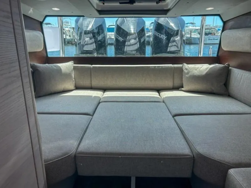 Slide: The Image of Interior of 2024 Axopar 45 XC Cross Cabin with gray seating and view of outboard motors. - 14