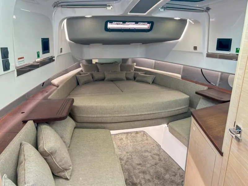 Slide: The Image of 2024 Axopar 45 XC Cross Cabin interior with modern seating and cushions. - 22