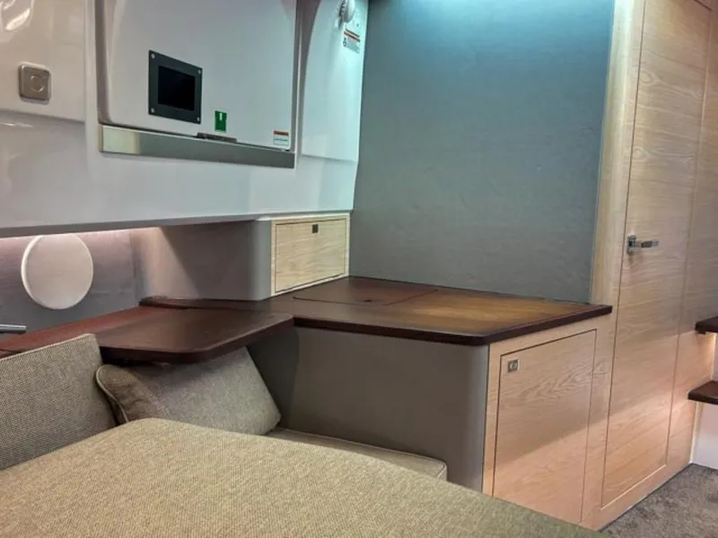 Slide: The Image of 2024 Axopar 45 XC Cross Cabin interior with modern wood and fabric design. - 27