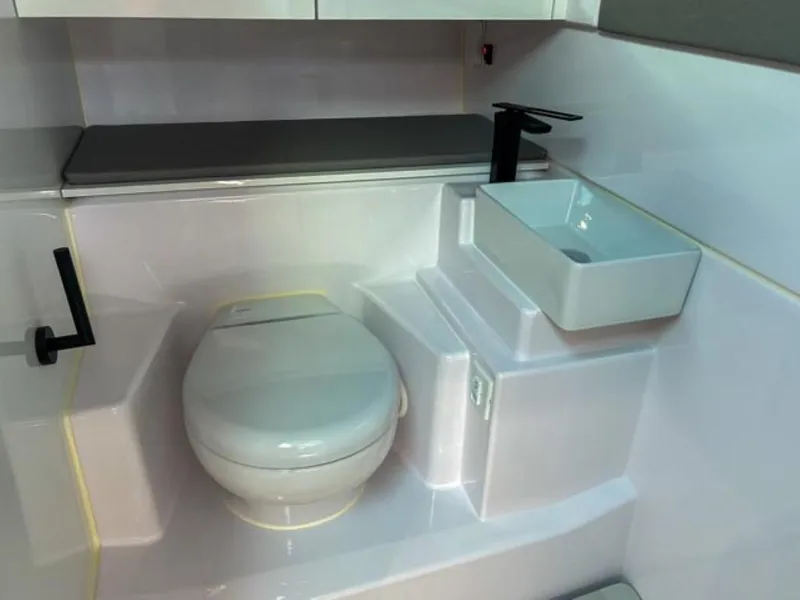 Slide: The Image of 2024 Axopar 45 XC Cross Cabin bathroom with modern toilet and sink. - 28