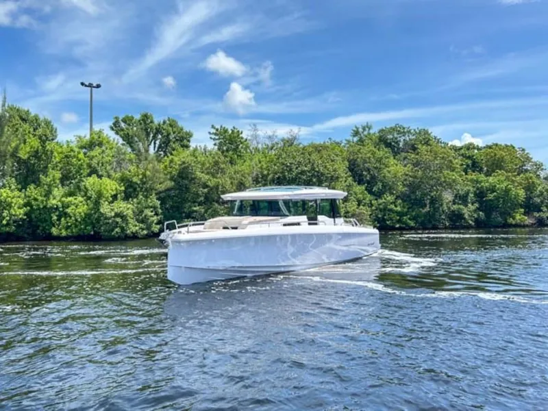 Slide: The Image of 2024 Axopar 45 XC Cross Cabin boat cruising on a sunny day. - 4