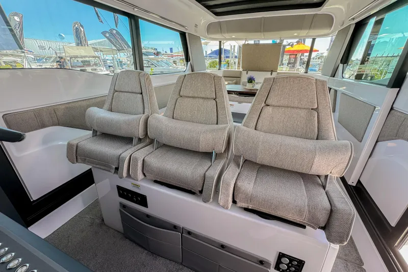 Slide: The Image of Interior of 2024 Axopar 45 XC Cross Cabin with three plush seats. - 9
