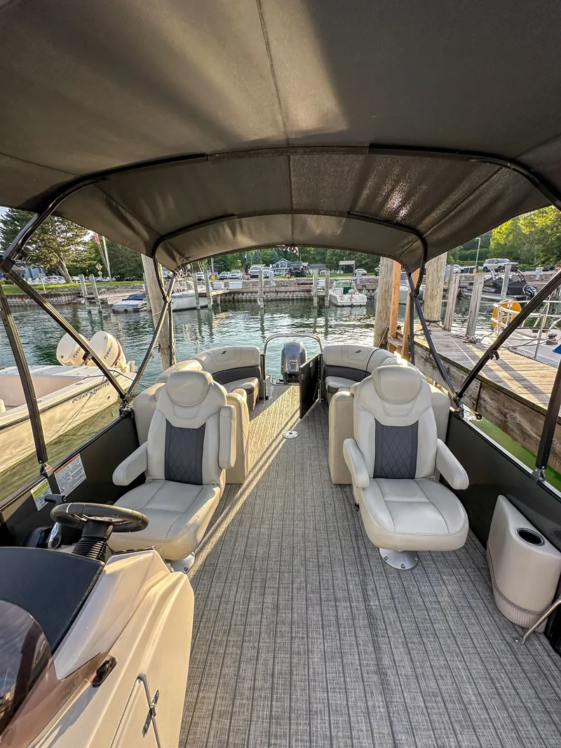 Slide: The Image of Interior of a 2021 Starcraft 25 SLS pontoon boat at dock. - 11
