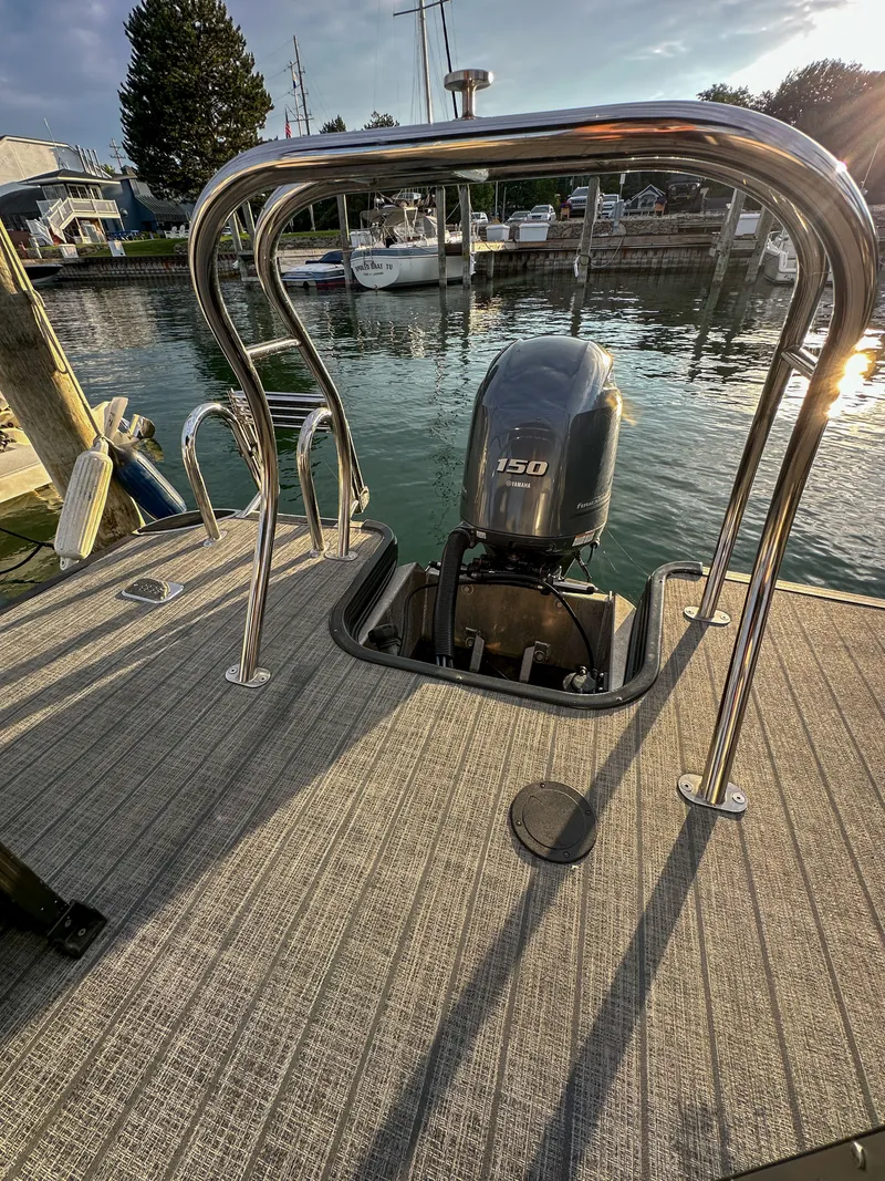Slide: The Image of Starcraft 25 SLS 2021 boat with outboard motor at dock. - 24