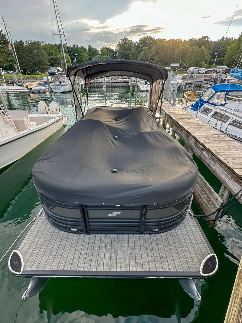 Slide: The Image of 2021 Starcraft 25 SLS pontoon boat docked at marina. - 32